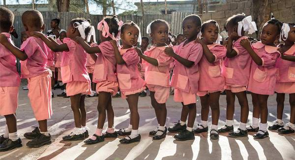 Very young children in their school uniforms. This image is not available under the 4.0 Creative Commons license.