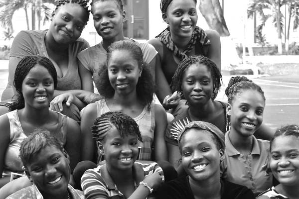 A group of young Black women seated together smiling. 