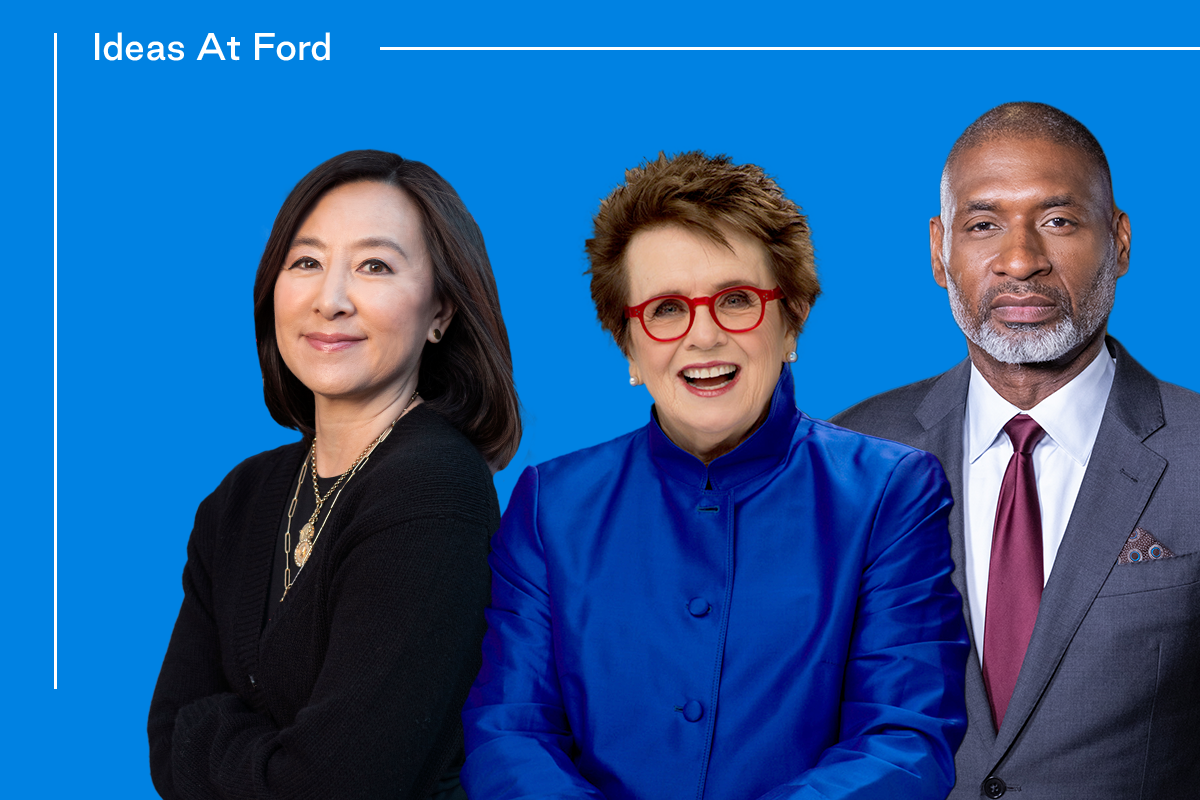 Three people stand confidently against a blue background with the text "Ideas At Ford." The group includes Clara Wu Tsai, in black, Billie Jean King, in a bright blue outfit and red glasses, and Charles Blow, in a suit and red tie.