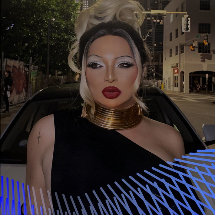 Gabriela, a Latina woman with platinum hair pulled into an updo, wears a stack of gold rings around her neck and a black dress that covers one shoulder. She leans against the hood of a white car, and behind her is a cityscape.