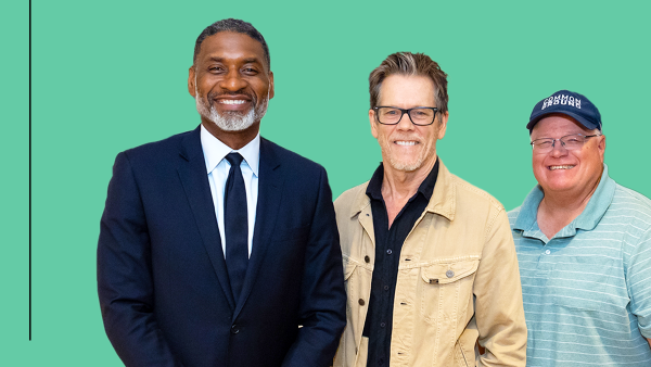 Three men stand side by side in front of a green background with “Ideas At Ford” written on it. Charles Blow, the first man on the left, wears a dark suit and tie. The middle man, Kevin Bacon, is wearing glasses and a beige jacket over a dark shirt. The man on the right, Gabe Brown, is wearing a blue cap and a striped polo shirt.