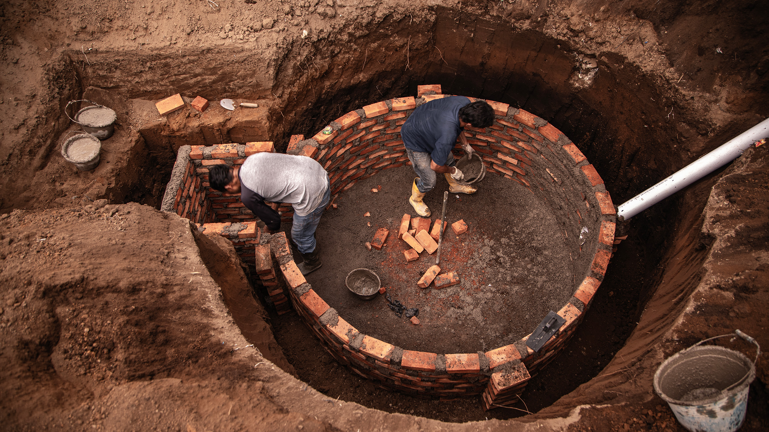 Workers making a reactor to store cow dung waste that can be used as energy for daily use, namely biogas that is processed directly by the community.