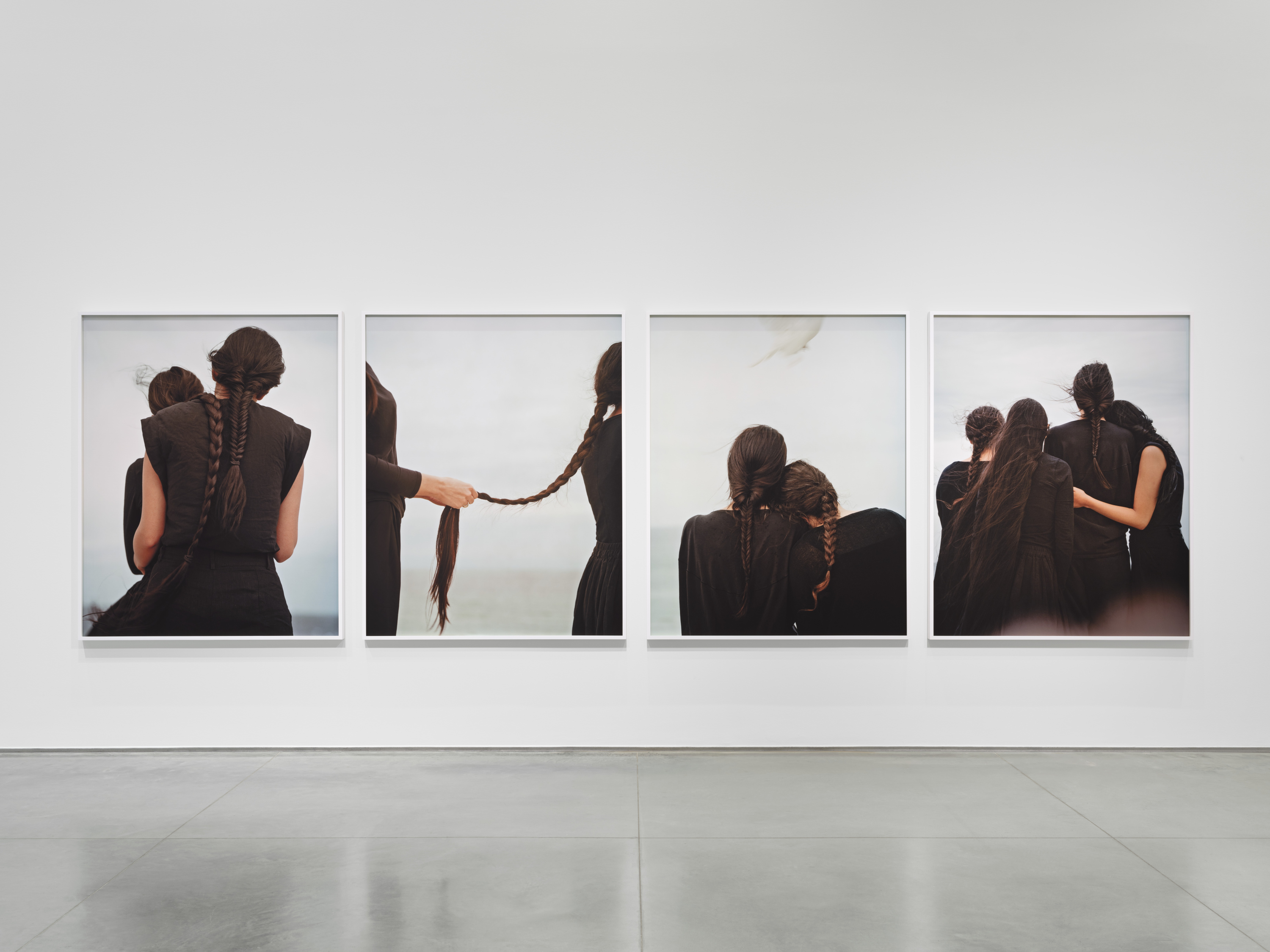 Four images arranged horizontally featuring women in black with long braided hair.