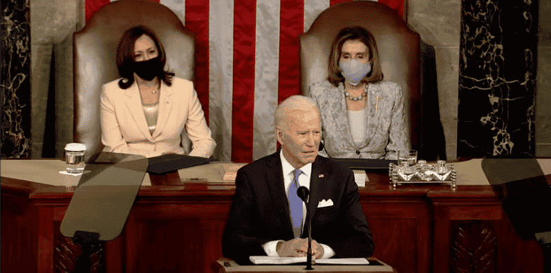 President Joe Biden addresses congress with Kamala Harris and Nancy Pelosi sitting in the background