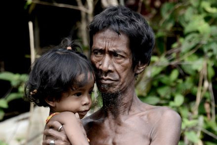 Defender of nature: An Orang Rimba tribesman carries his child near their camp in Batang Hari regency, Jambi, on May 19, 2017. The Orang Rimba are an indigenous community of an estimated 70 million people and play a pivotal role in environmental protection.